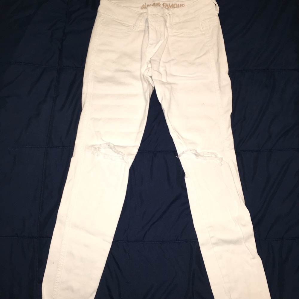 White jeans with ripped knees